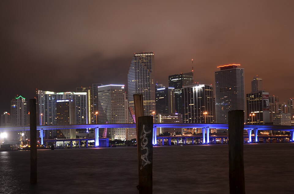 Downtown Miami skyline illuminated across Biscayne Bay in an archival photograph